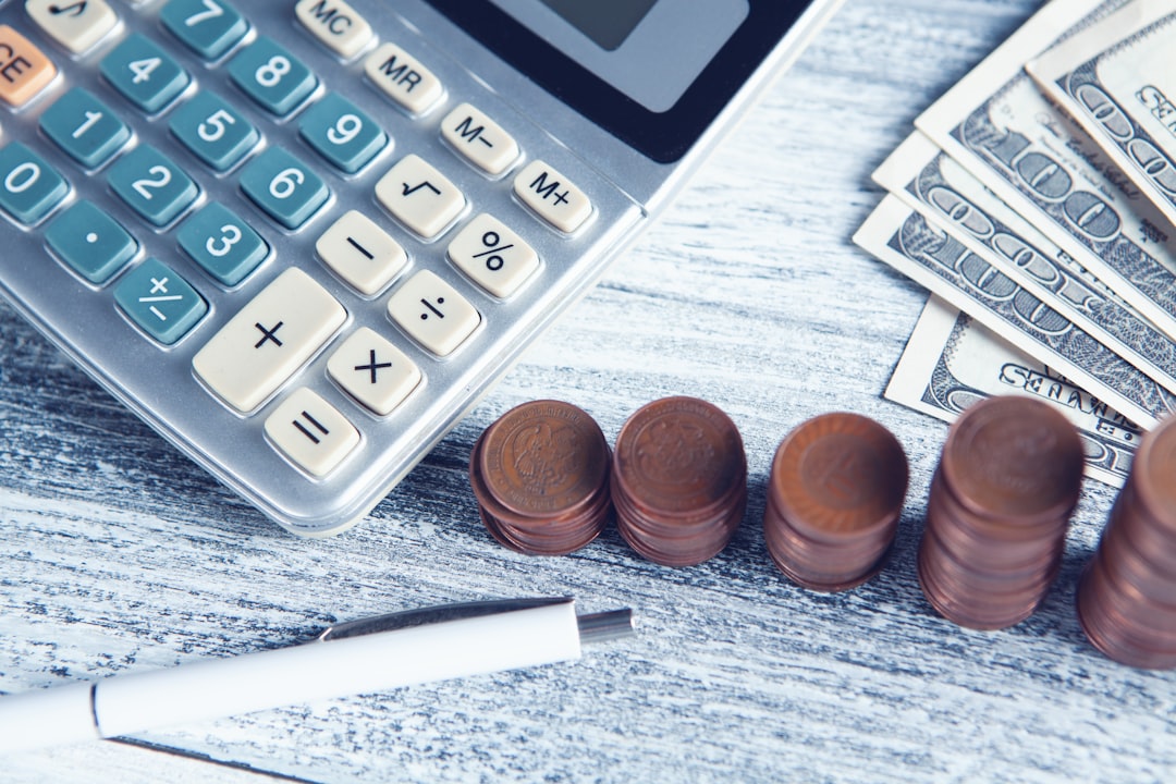 a-calculator-pen-and-money-on-a-table-x4vwfpzy-2o